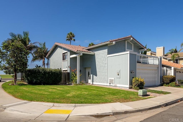 view of front facade with a balcony, driveway, a front lawn, and an attached garage