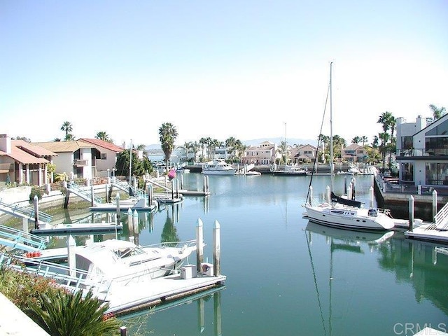 view of dock featuring a water view and a residential view