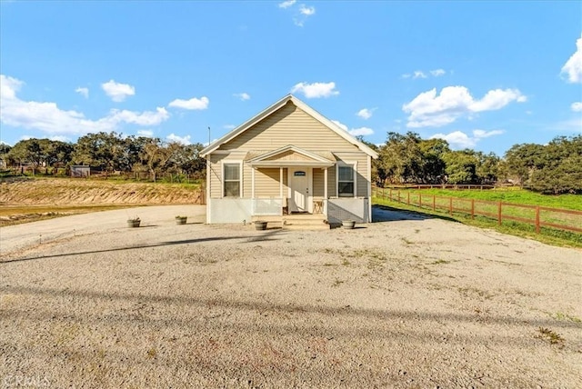 view of front of property featuring a rural view and fence