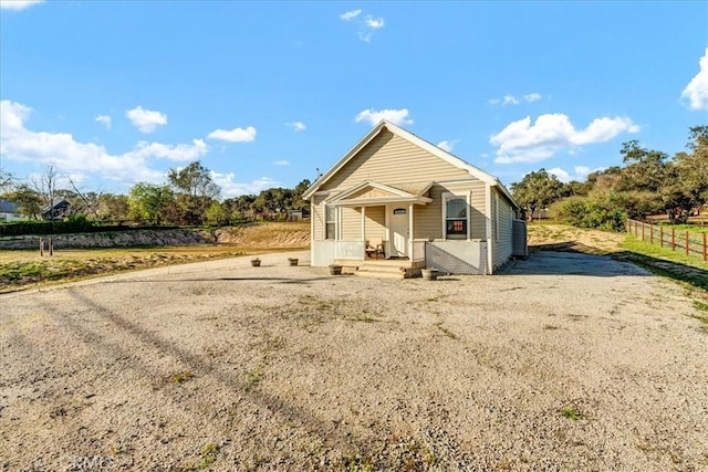 bungalow-style house with fence