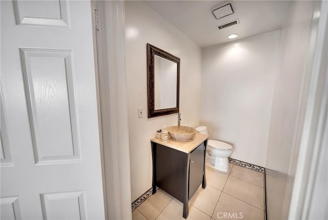 bathroom featuring visible vents, toilet, tile patterned floors, vanity, and recessed lighting