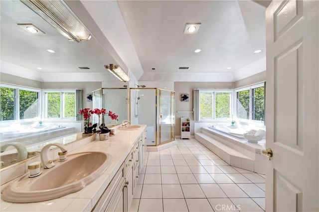 full bath featuring double vanity, tile patterned flooring, a sink, and a bath