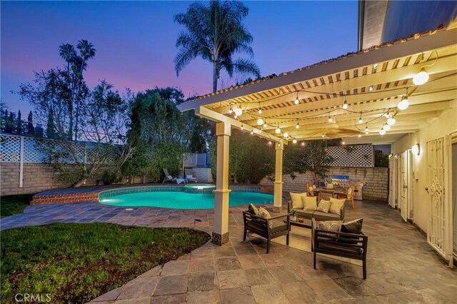 pool at dusk with a pergola, a fenced backyard, and a patio area