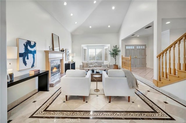 living room with recessed lighting, baseboards, stairway, high vaulted ceiling, and a high end fireplace