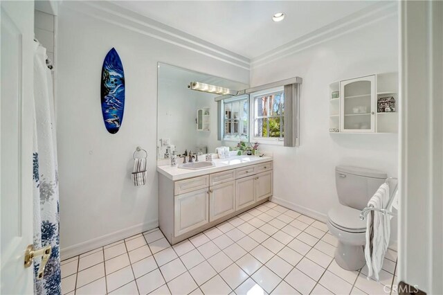 bathroom with toilet, baseboards, a sink, and tile patterned flooring