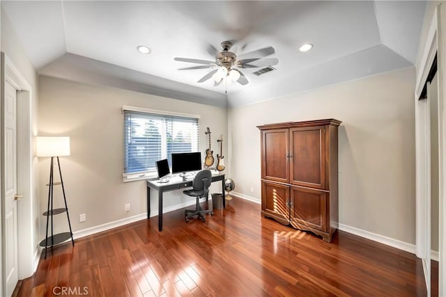 home office featuring visible vents, dark wood-type flooring, a ceiling fan, and baseboards