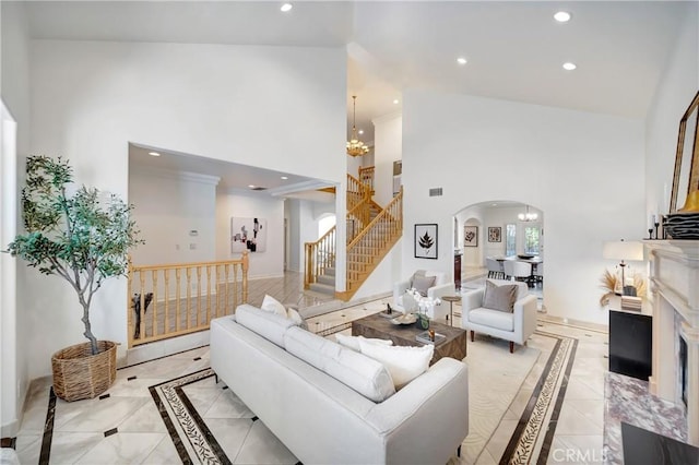 living room featuring stairs, high vaulted ceiling, recessed lighting, a chandelier, and arched walkways