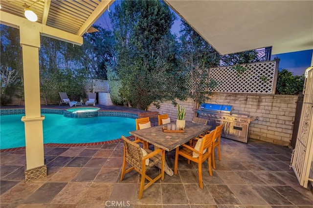 view of swimming pool featuring outdoor dining space, a patio area, a fenced backyard, and a pool with connected hot tub