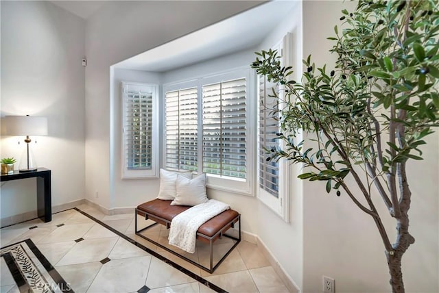 living area with light tile patterned flooring and baseboards