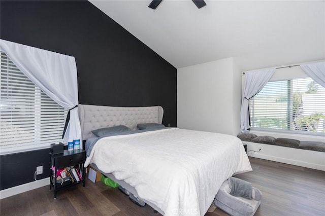 bedroom with a ceiling fan, baseboards, vaulted ceiling, and wood finished floors