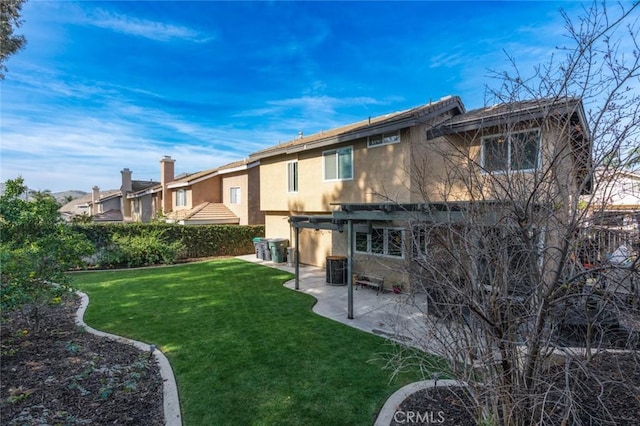 rear view of property with a patio, fence, a lawn, and stucco siding