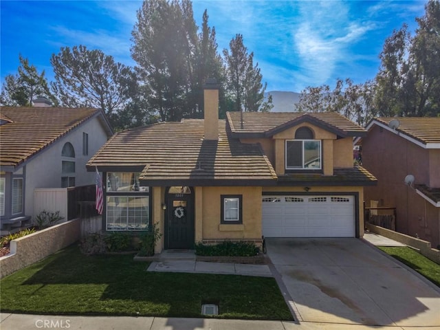 view of front of property with driveway, a garage, a tiled roof, a front lawn, and stucco siding