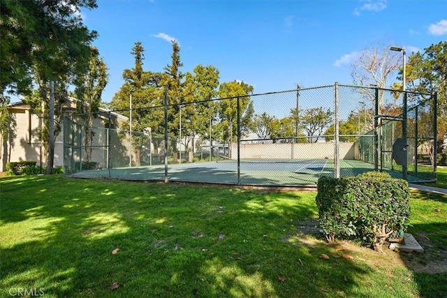 view of sport court with a yard, fence, and community basketball court