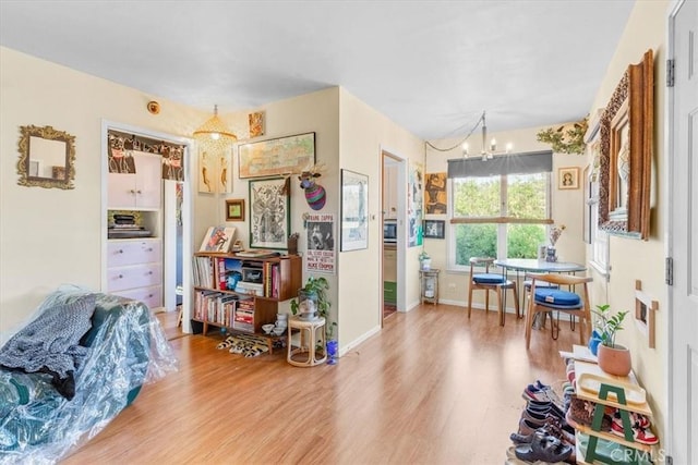 interior space with a chandelier, baseboards, and wood finished floors