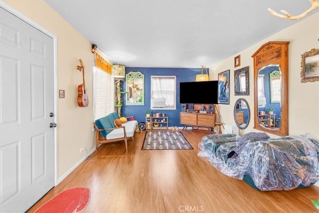 living area with wood finished floors and baseboards