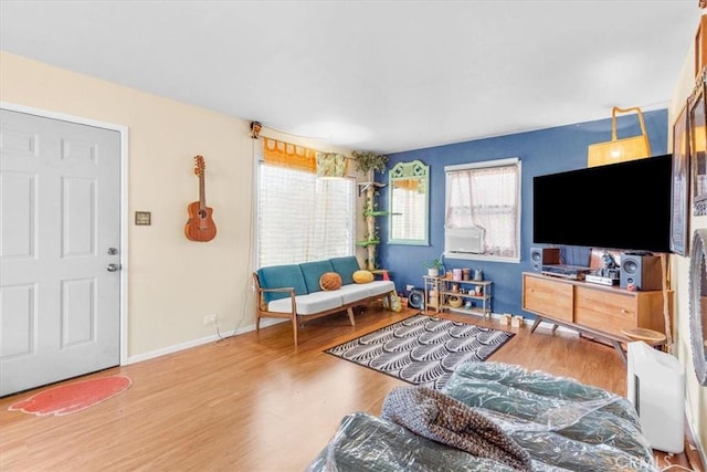 living room with baseboards and wood finished floors