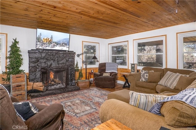 sunroom / solarium featuring wooden ceiling and a fireplace