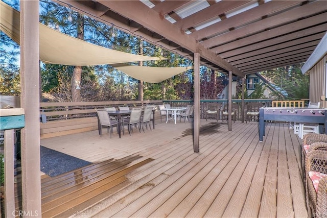 wooden terrace with outdoor dining space