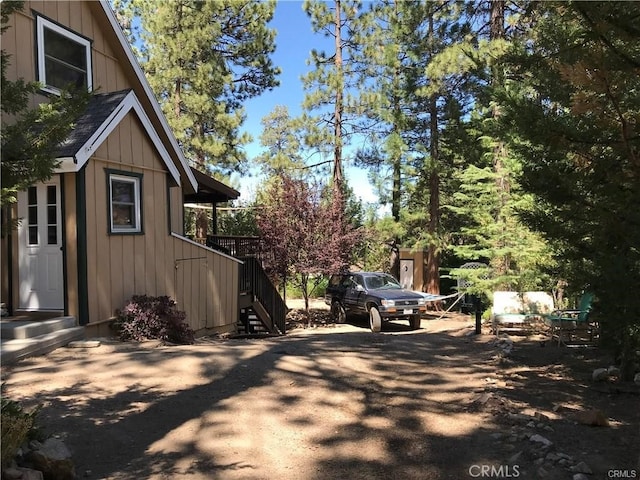 view of side of home featuring stairway and board and batten siding