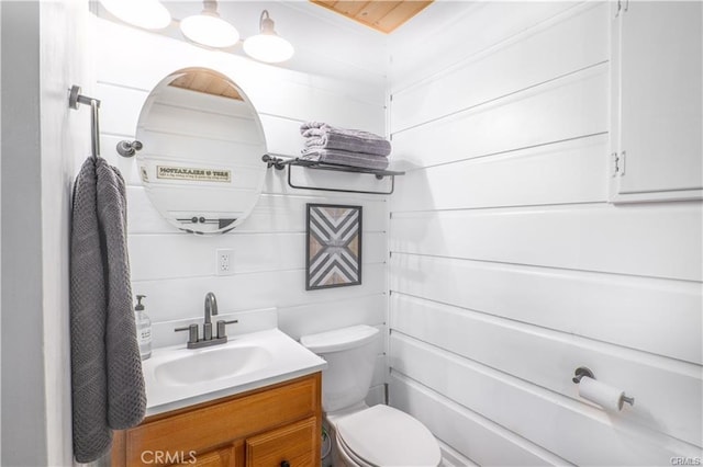 bathroom featuring toilet and vanity