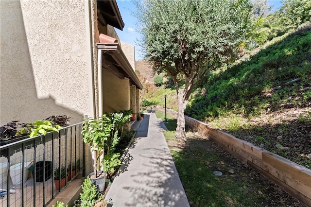 view of property exterior featuring stucco siding and fence