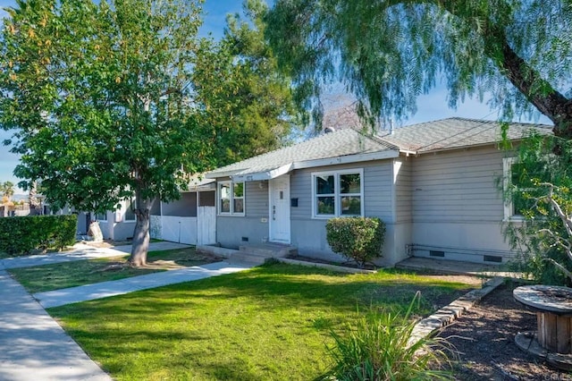 ranch-style home featuring a front yard, crawl space, and roof with shingles