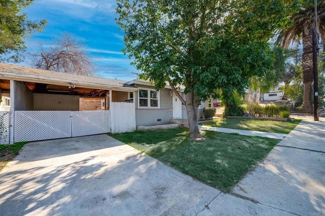 view of front of home with a carport, a front lawn, concrete driveway, and stucco siding