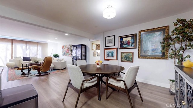 dining space featuring recessed lighting, wood finished floors, and baseboards