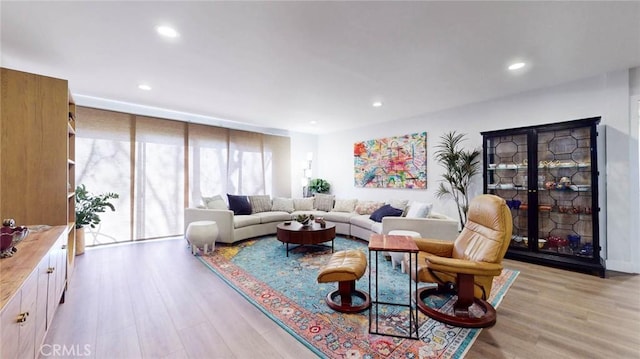 living room with recessed lighting, expansive windows, and light wood finished floors