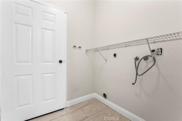 clothes washing area featuring baseboards, laundry area, washer hookup, and hookup for an electric dryer