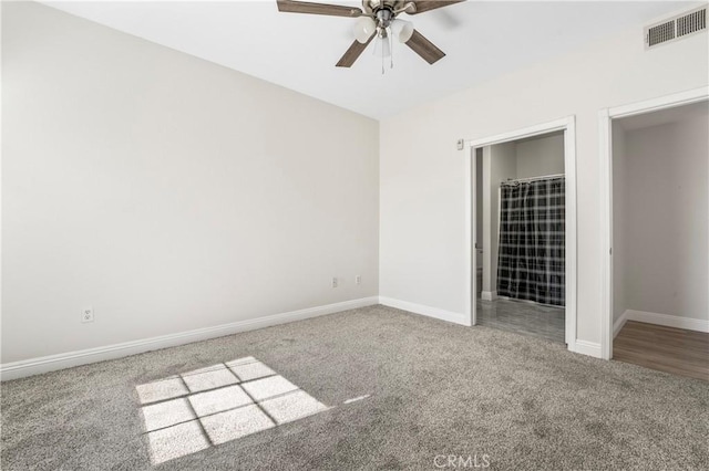 unfurnished bedroom with carpet, visible vents, ensuite bath, and baseboards