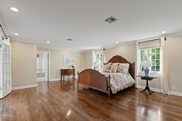 bedroom with visible vents, crown molding, and wood finished floors