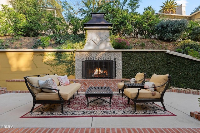 view of patio with an outdoor living space with a fireplace