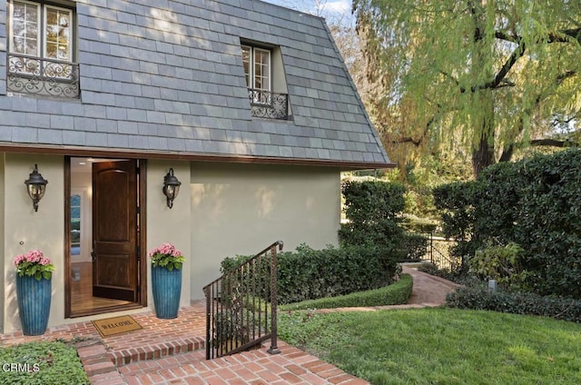 entrance to property featuring stucco siding