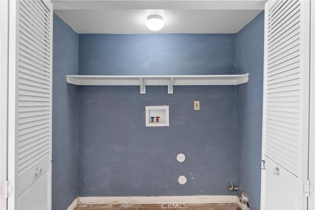 laundry area with baseboards and washer hookup