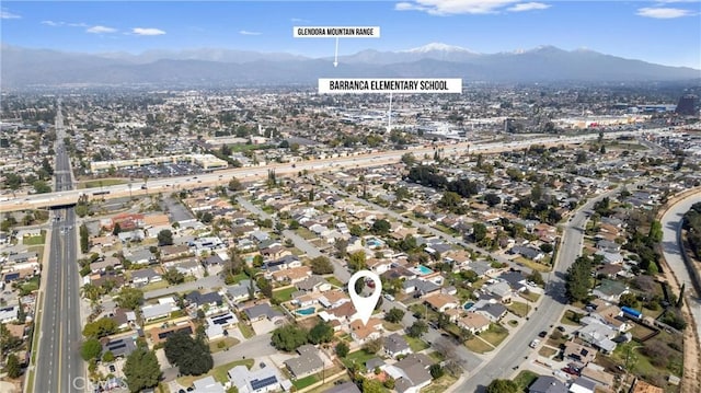 birds eye view of property featuring a mountain view