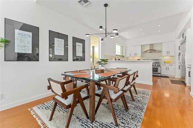 dining area with visible vents, baseboards, light wood-style flooring, a chandelier, and recessed lighting