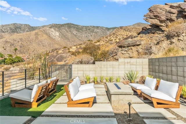 view of patio / terrace featuring a fenced backyard, a mountain view, and an outdoor hangout area