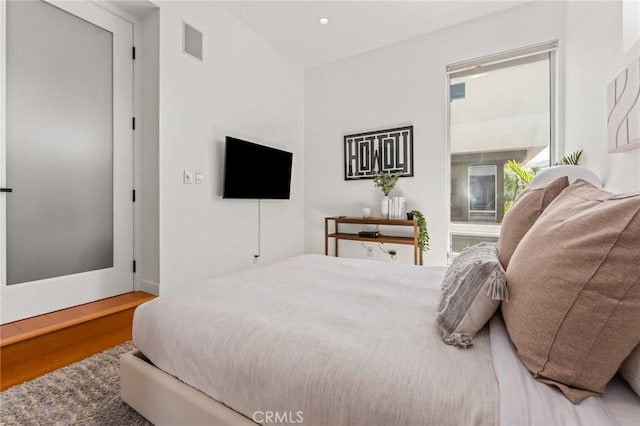 bedroom with visible vents, wood finished floors, and recessed lighting