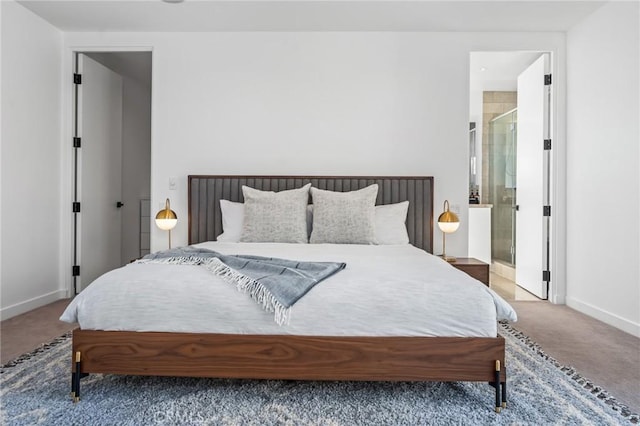 carpeted bedroom featuring connected bathroom and baseboards