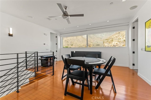 dining space featuring wood finished floors and baseboards