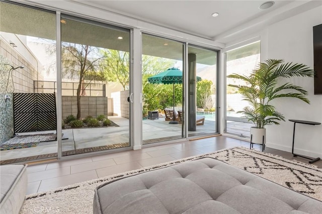 doorway to outside featuring a wall of windows, recessed lighting, and tile patterned floors