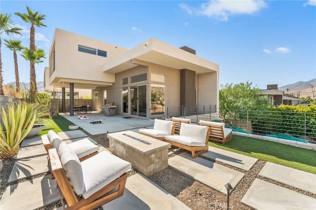 view of patio / terrace with a fire pit, fence, and a grill