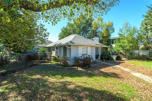 view of side of property featuring a fenced backyard and a lawn