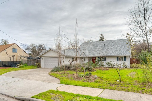 view of front of home featuring an attached garage, a shingled roof, fence, concrete driveway, and a front lawn