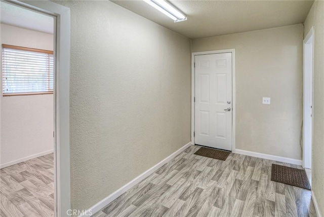 interior space featuring light wood finished floors and baseboards