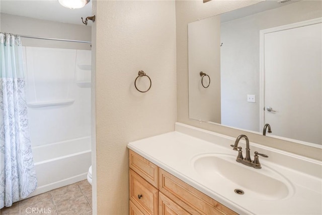 bathroom with shower / bathtub combination with curtain, vanity, toilet, and tile patterned floors