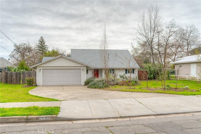 ranch-style home featuring a garage, driveway, a front lawn, and fence