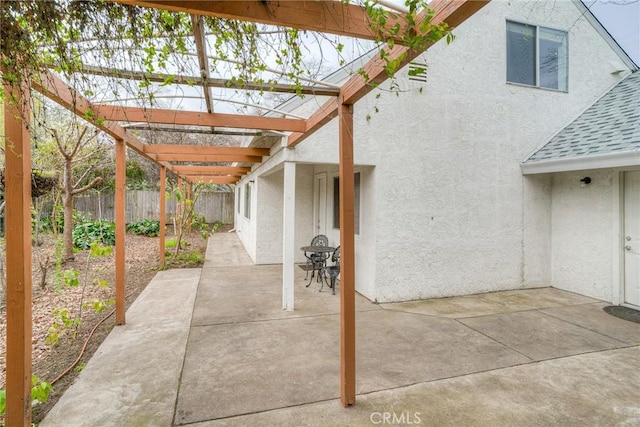 view of patio featuring fence and a pergola