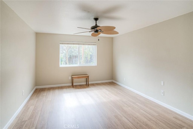 unfurnished room featuring baseboards, ceiling fan, and light wood finished floors